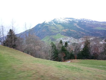 Scenic view of landscape and mountains against sky