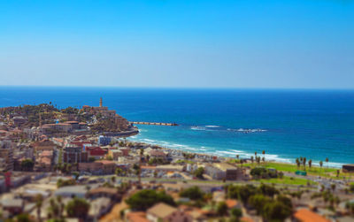 High angle view of sea and buildings against sky