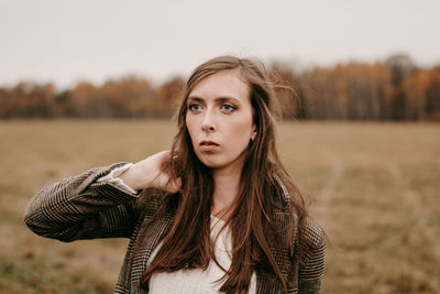 Sad girl with blue eyes. portrait of a girl in brown tones. walk through the woods. autumn colors. 