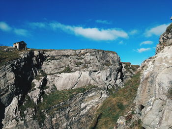 Low angle view of rock formations against sky