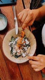 Woman eating healthy salmon cuscus salad