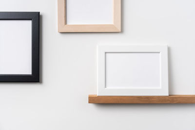 Close-up of white table against wall at home