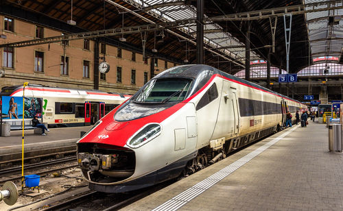 Train on railroad tracks in city against sky