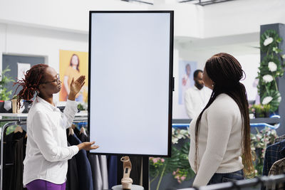 Rear view of business colleagues working in office