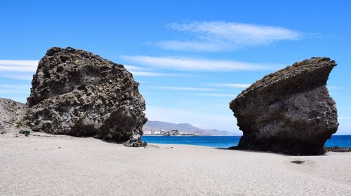 Rocks on beach against sky