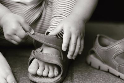 Low section of baby girl wearing sandals