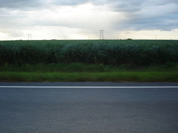 Road by landscape against sky