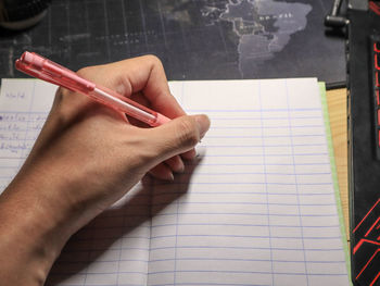 Close-up of hand holding to write note