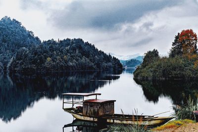 View of boats moored in calm lake