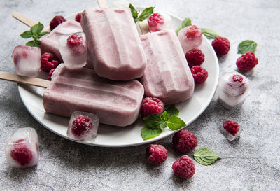Homemade raspberry ice cream and fresh raspberries. summer food.