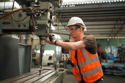 Side view of man working in factory