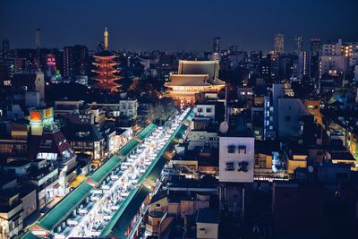 High angle view of illuminated buildings in city at night