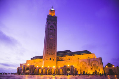 Low angle view of illuminated buildings against sky at dusk