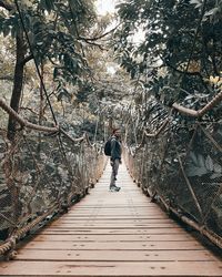 Rear view of man walking on footpath