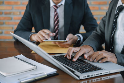 Midsection of business colleagues working at office