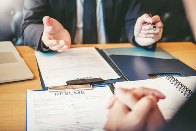 Midsection of man using laptop on table