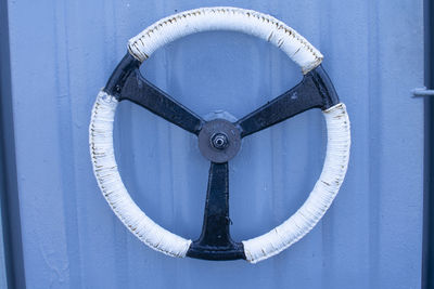 Close-up of metal chain against blue wall