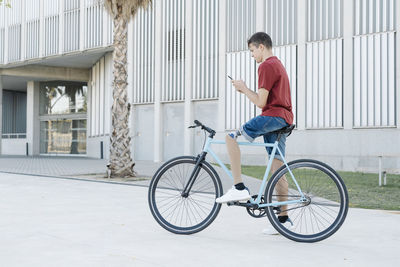 Disabled cyclist using phone on street