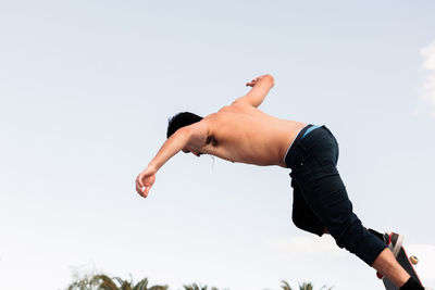 Young skater standing at the top of the skate ramp