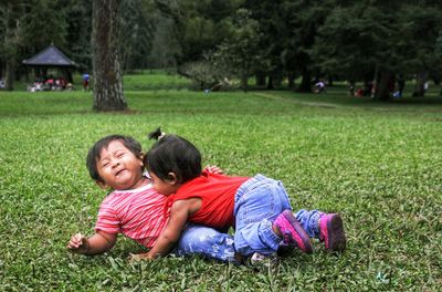 Babies playing on grassy land in park