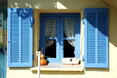 Blue window shutters in a mediterranean village. corsica, france