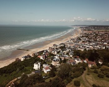 High angle view of sea and buildings against sky