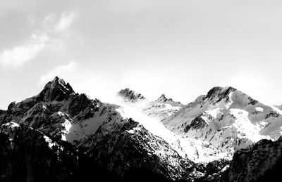 Low angle view of snowcapped mountain against sky