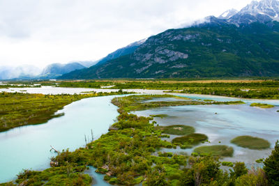 Scenic view of lake and mountains against sky