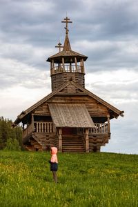 Built structure on field against sky