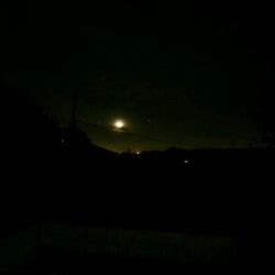 Scenic view of illuminated landscape against sky at night