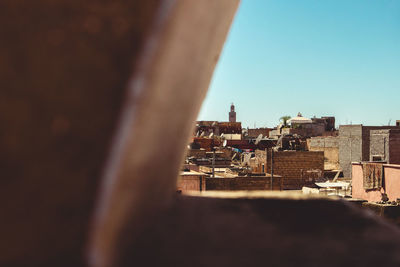 Buildings in city against clear sky