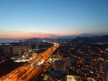 High angle view of illuminated buildings against sky at night