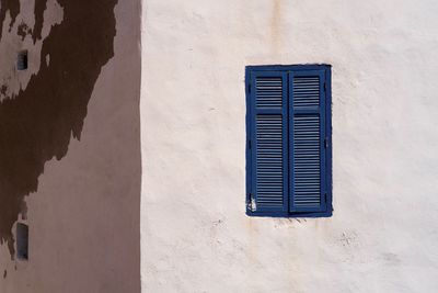 Low angle view of window on wall of building