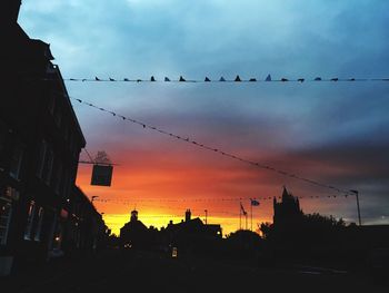 Low angle view of silhouette birds flying against sky