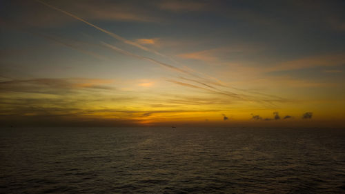 Scenic view of sea against orange sky