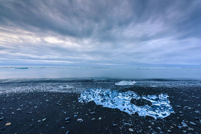 Scenic view of sea against sky during winter