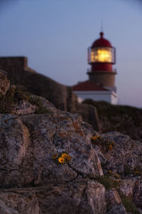 View of lighthouse and buildings against sky