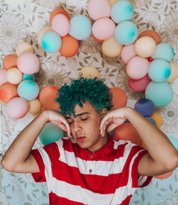 High angle portrait of man with multi colored candies