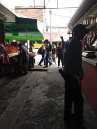 Group of people walking on street in city