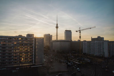 Fernsehturm tower with cityscape against sky during sunset