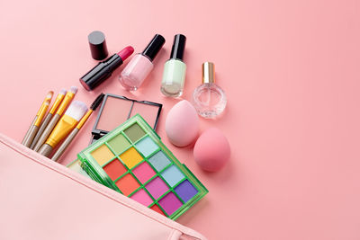 High angle view of beauty products on pink background