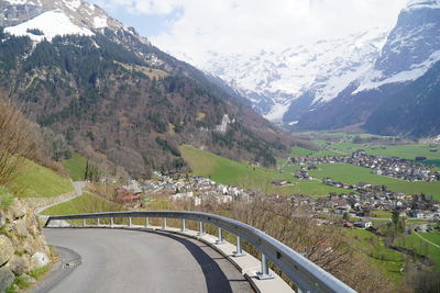 Road leading towards mountains against sky