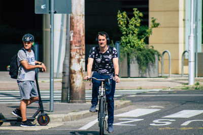 Portrait of smiling young man riding bicycle on city