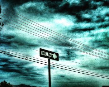 Low angle view of road sign against sky