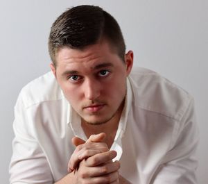 Portrait of young man against white background