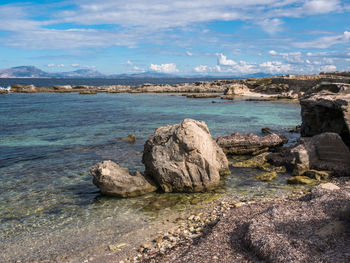 Rocks on shore against sky