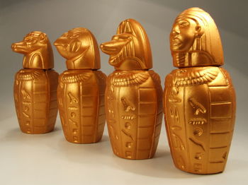 Close-up of canopic jars against white background