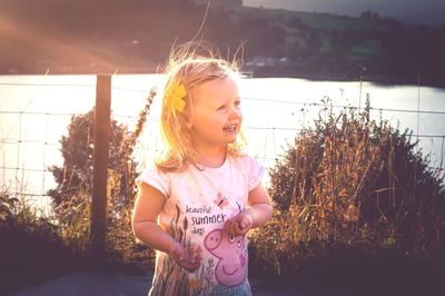 Happy girl standing outdoors