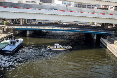 Boats in river with buildings in background