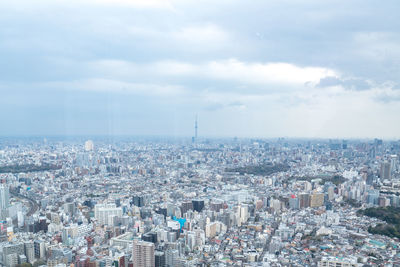 High angle view of city against cloudy sky